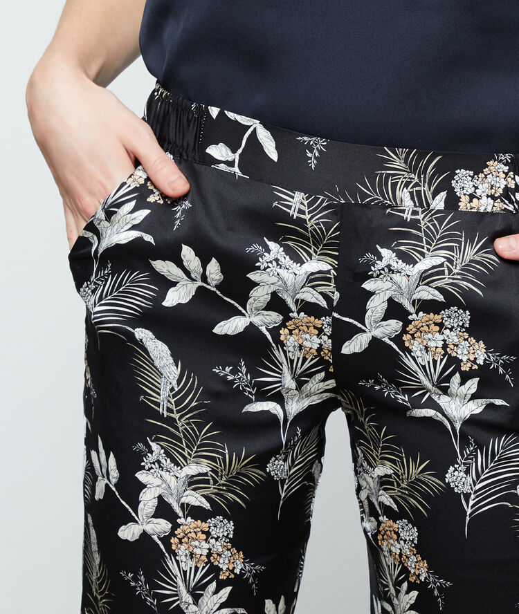 Pantalon imprimé feuillage noir.