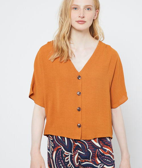 Blouse met v-hals en knopen specerij.